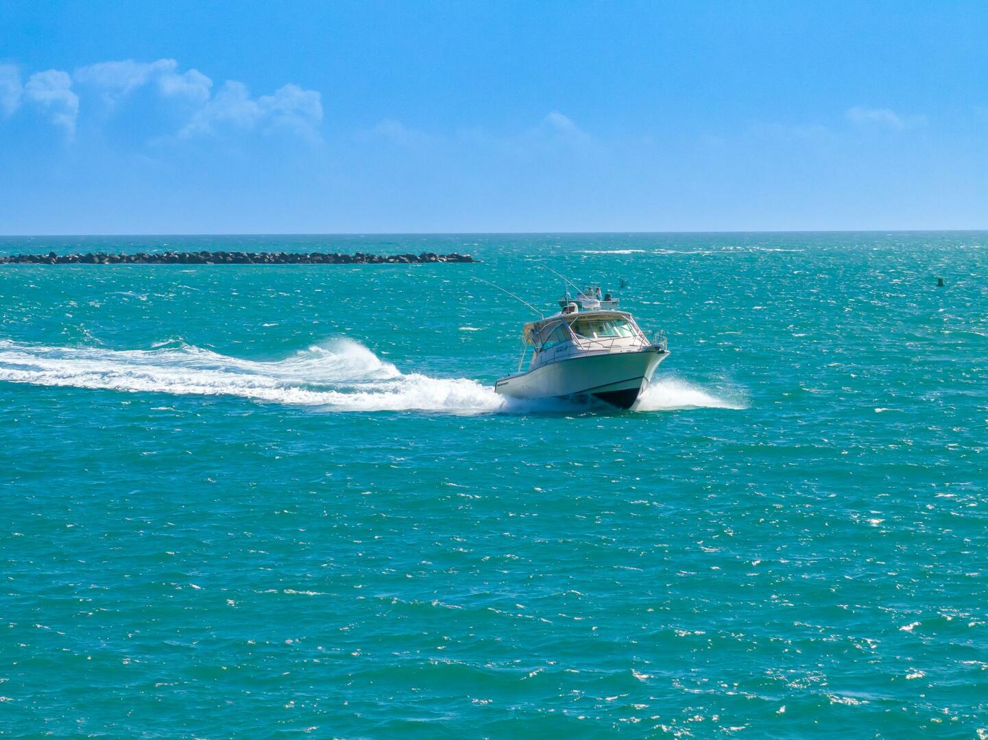 2007 Grady-White Express 360 boat cruising on turquoise ocea