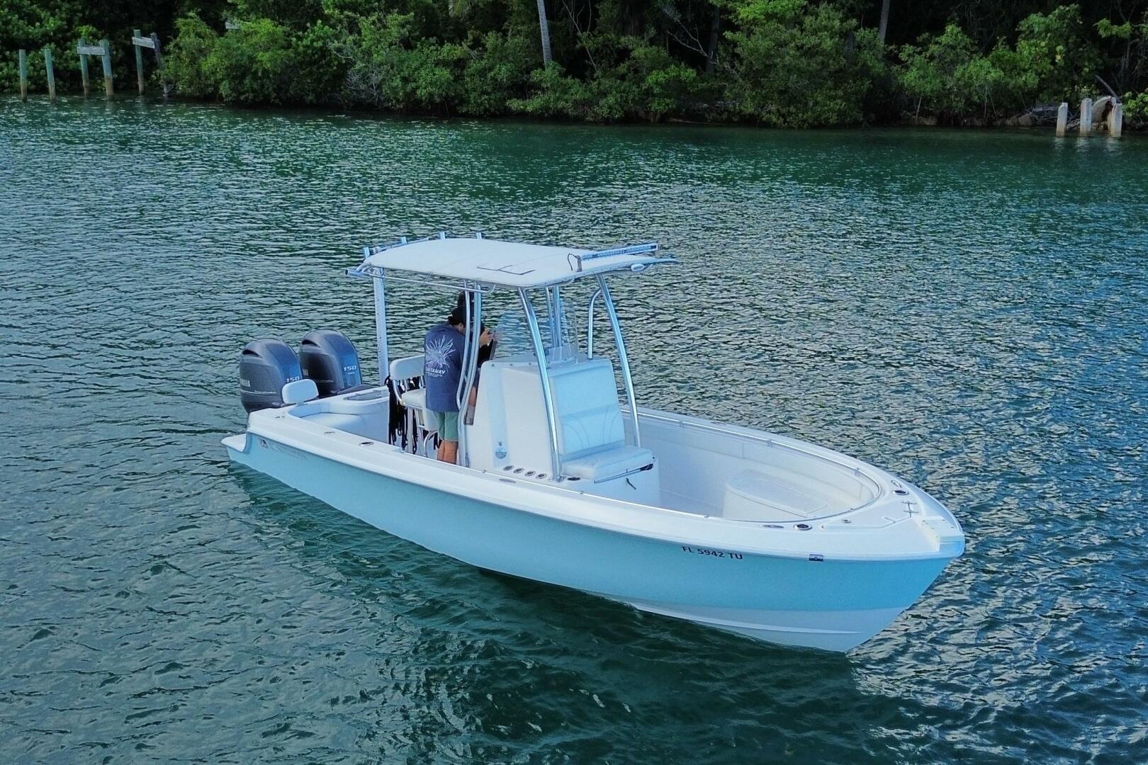 2023 Contender 24 Sport boat on calm water, featuring dual e