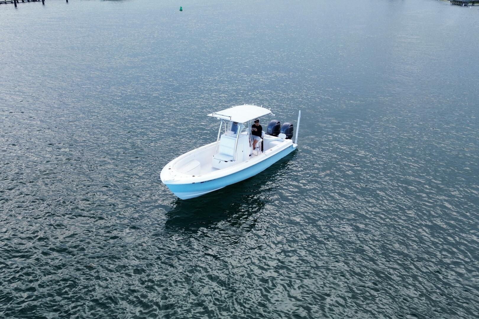 2023 Contender 24 Sport boat cruising on calm waters.
