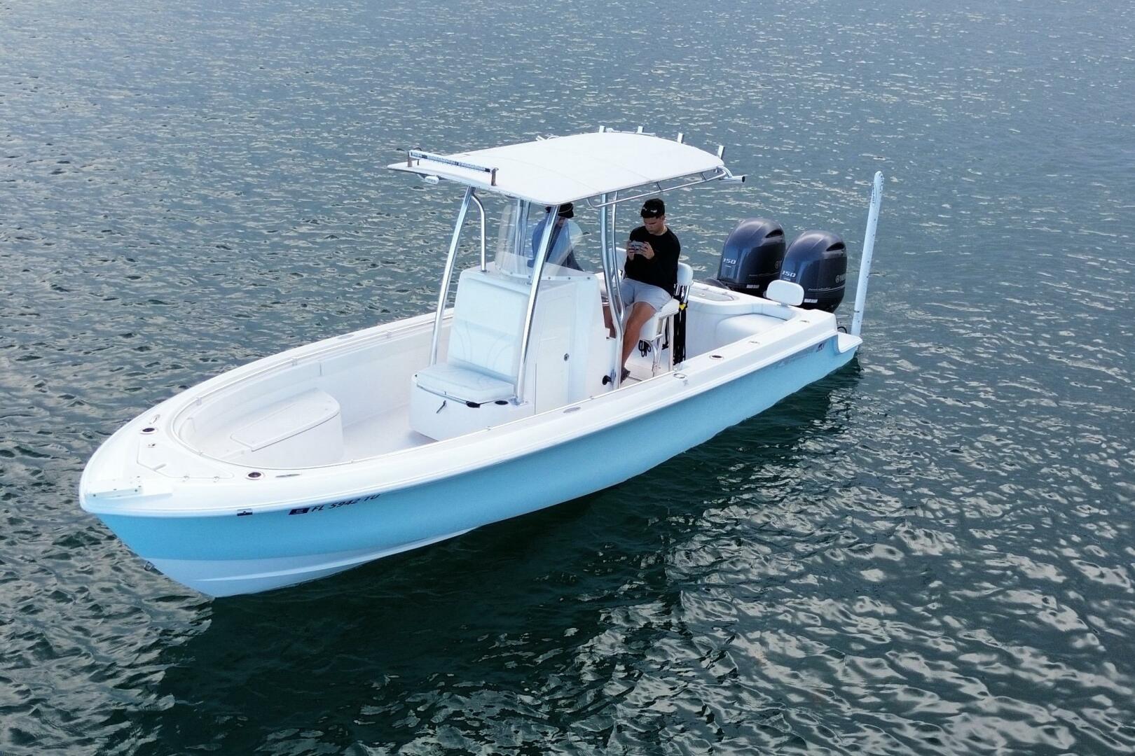 2023 Contender 24 Sport boat on water, featuring dual engine