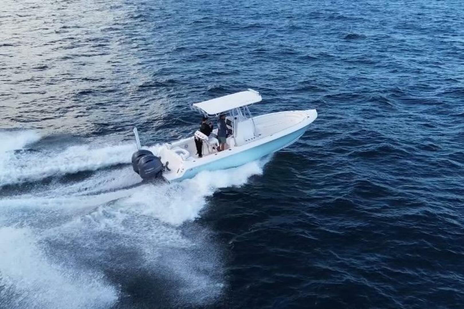 2023 Contender 24 Sport boat cruising on open water, creatin