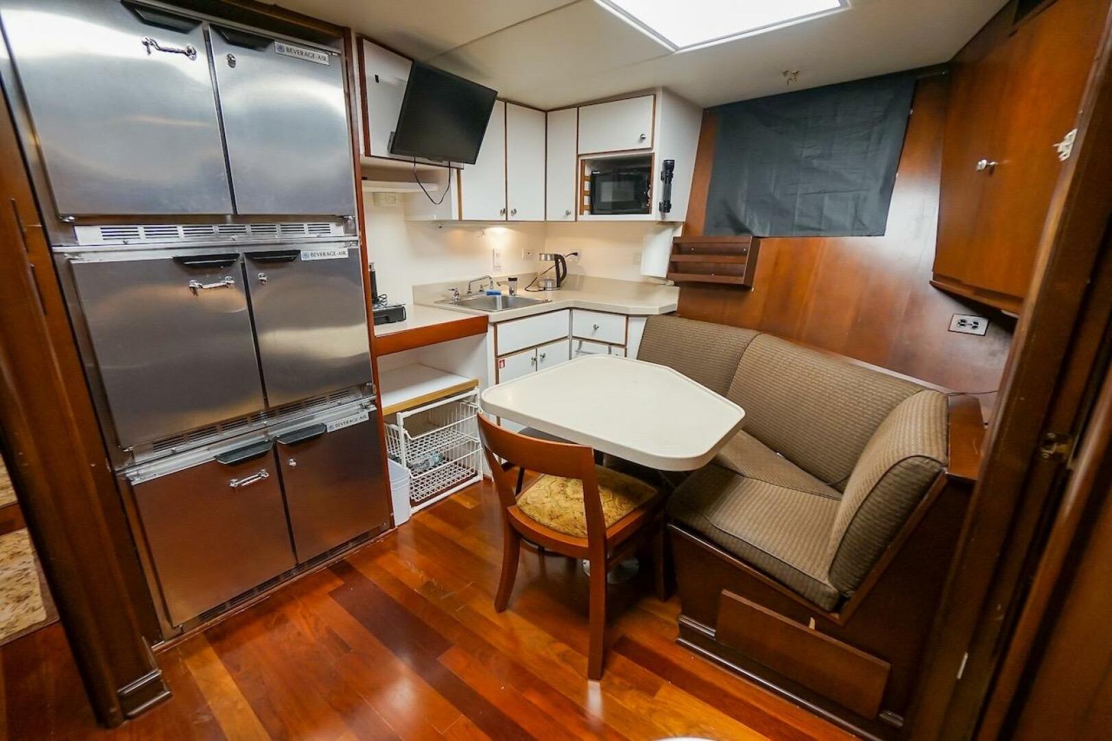 Cozy 1996 ABD 90 Explorer yacht kitchen with dining nook and