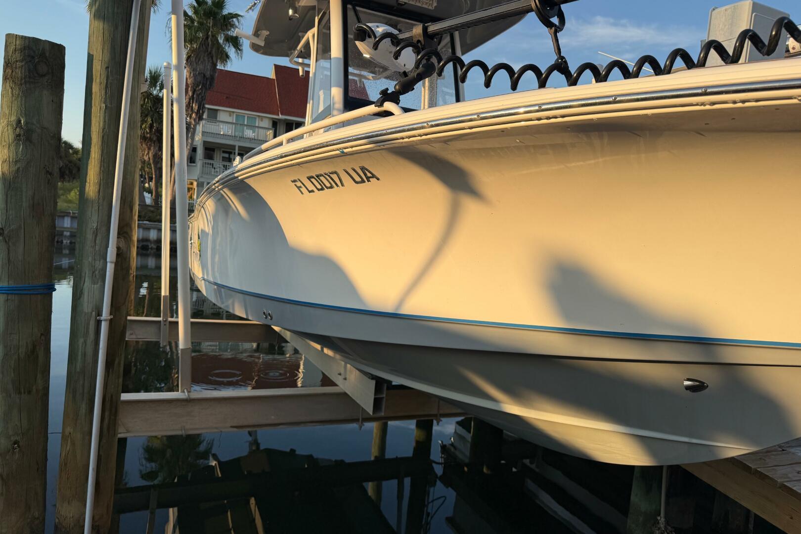 2018 Sea Hunt BX 25 FS boat docked, reflecting sunlight, wit
