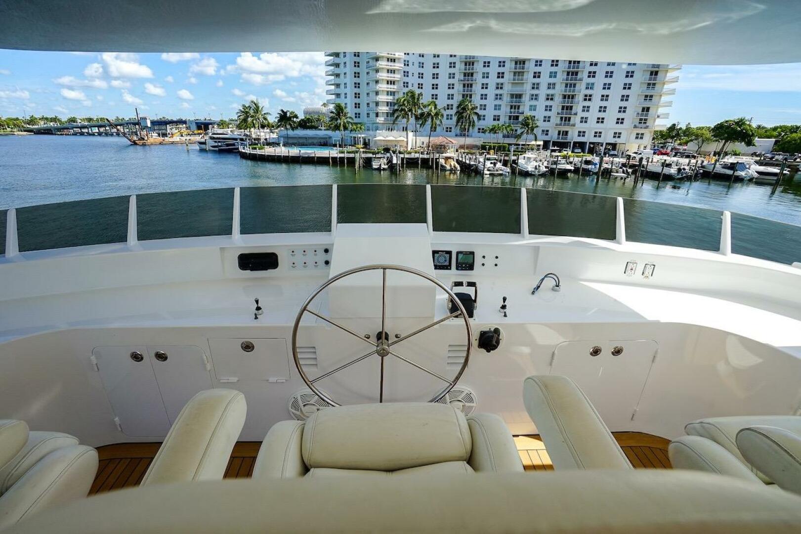 Luxurious yacht helm with white leather seats, overlooking a
