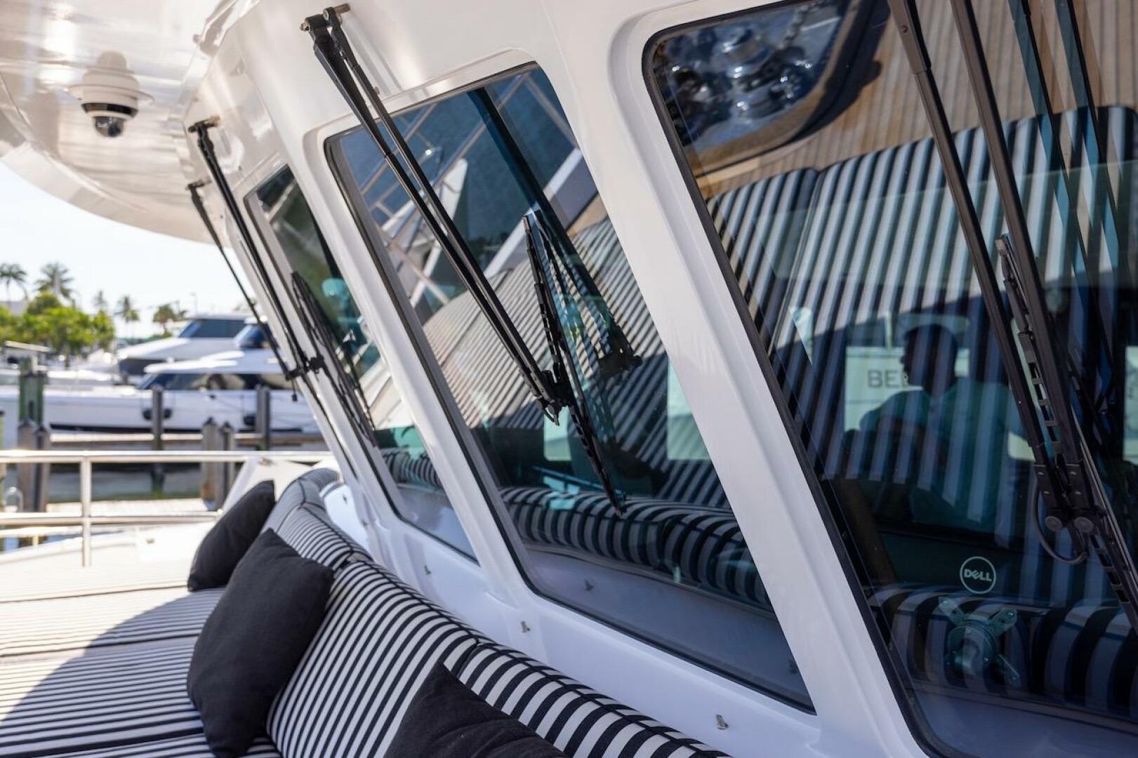 Luxury yacht with striped seating, featuring sleek windows a