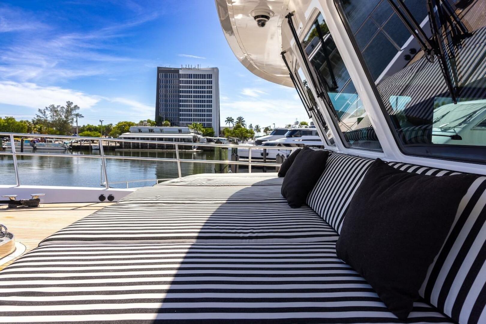 Luxurious ABD 90 Explorer yacht with striped seating, docked
