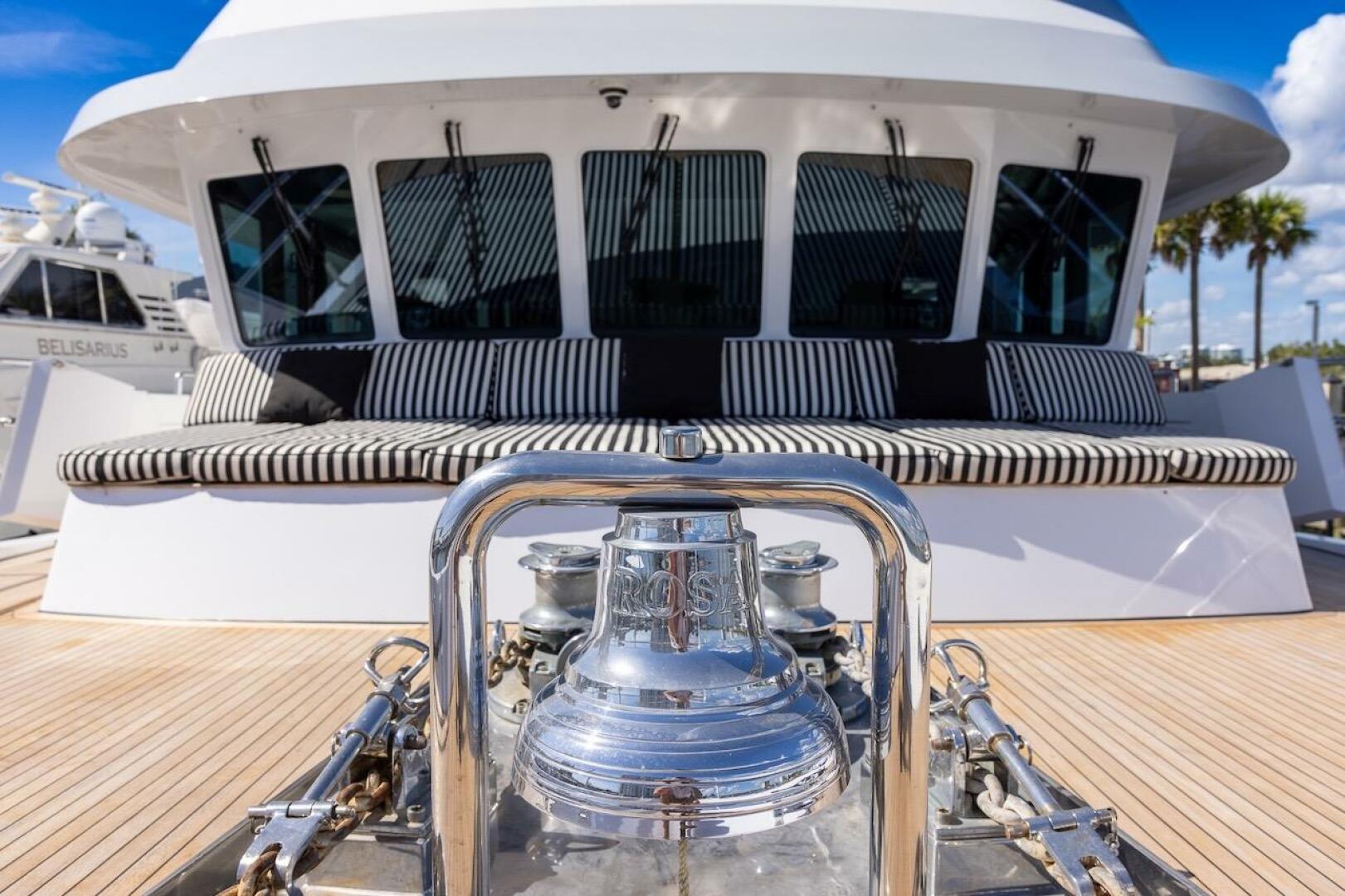Luxury yacht deck with striped seating and polished bell, AB
