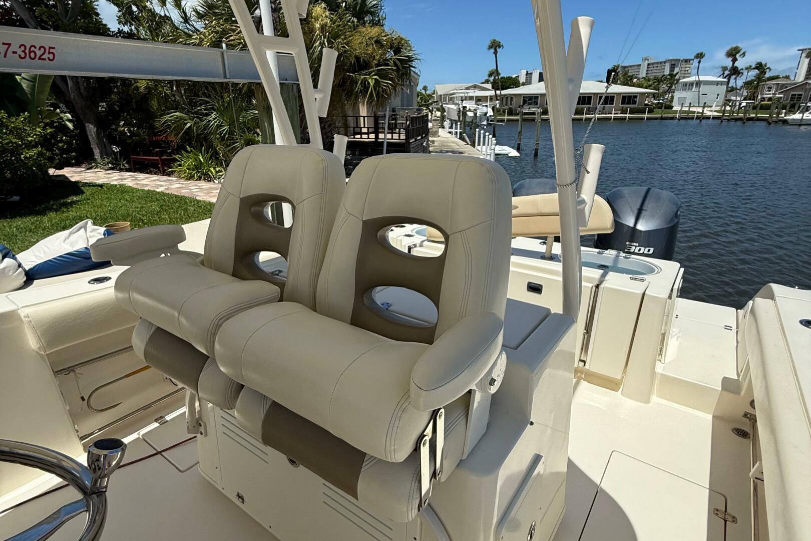 2015 Cobia 296 Center Console boat with beige seating, docke