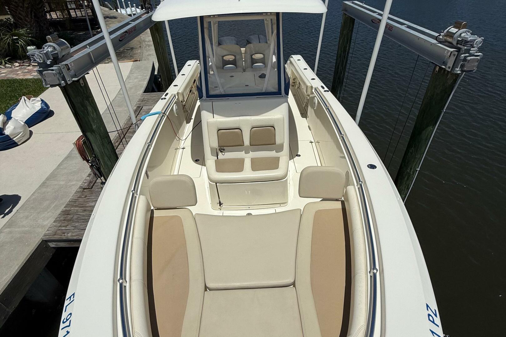 2015 Cobia 296 Center Console boat docked, featuring spaciou