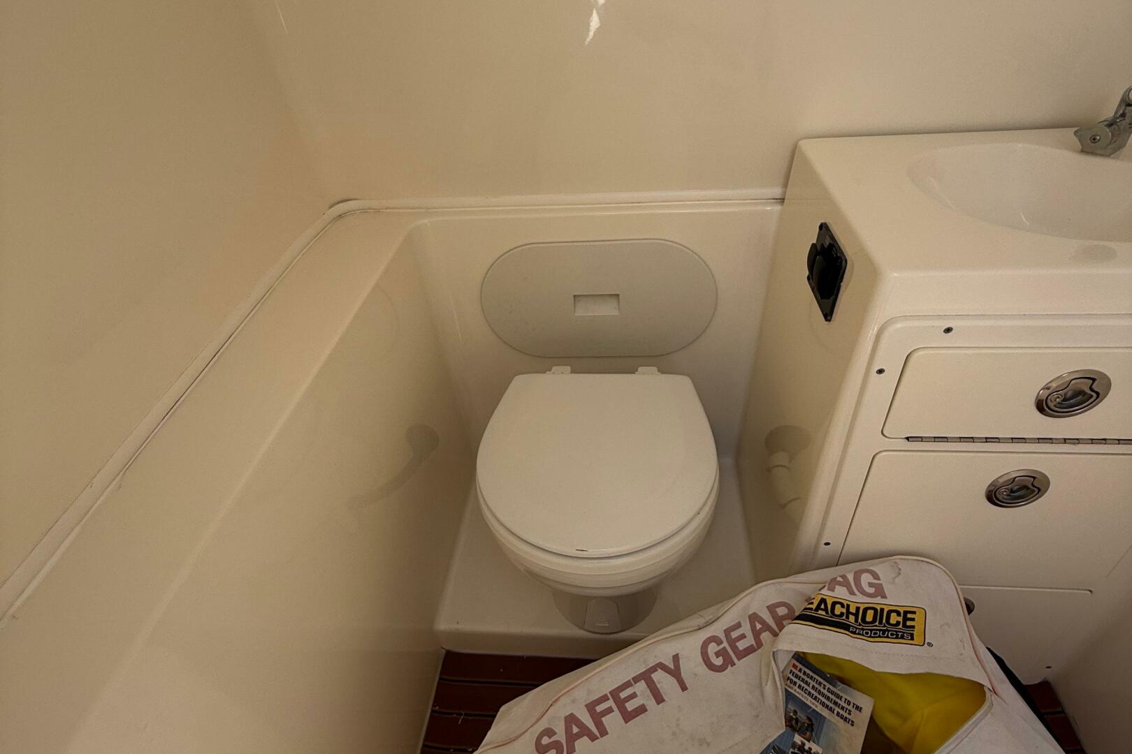 2015 Cobia 296 Center Console boat bathroom with toilet and 