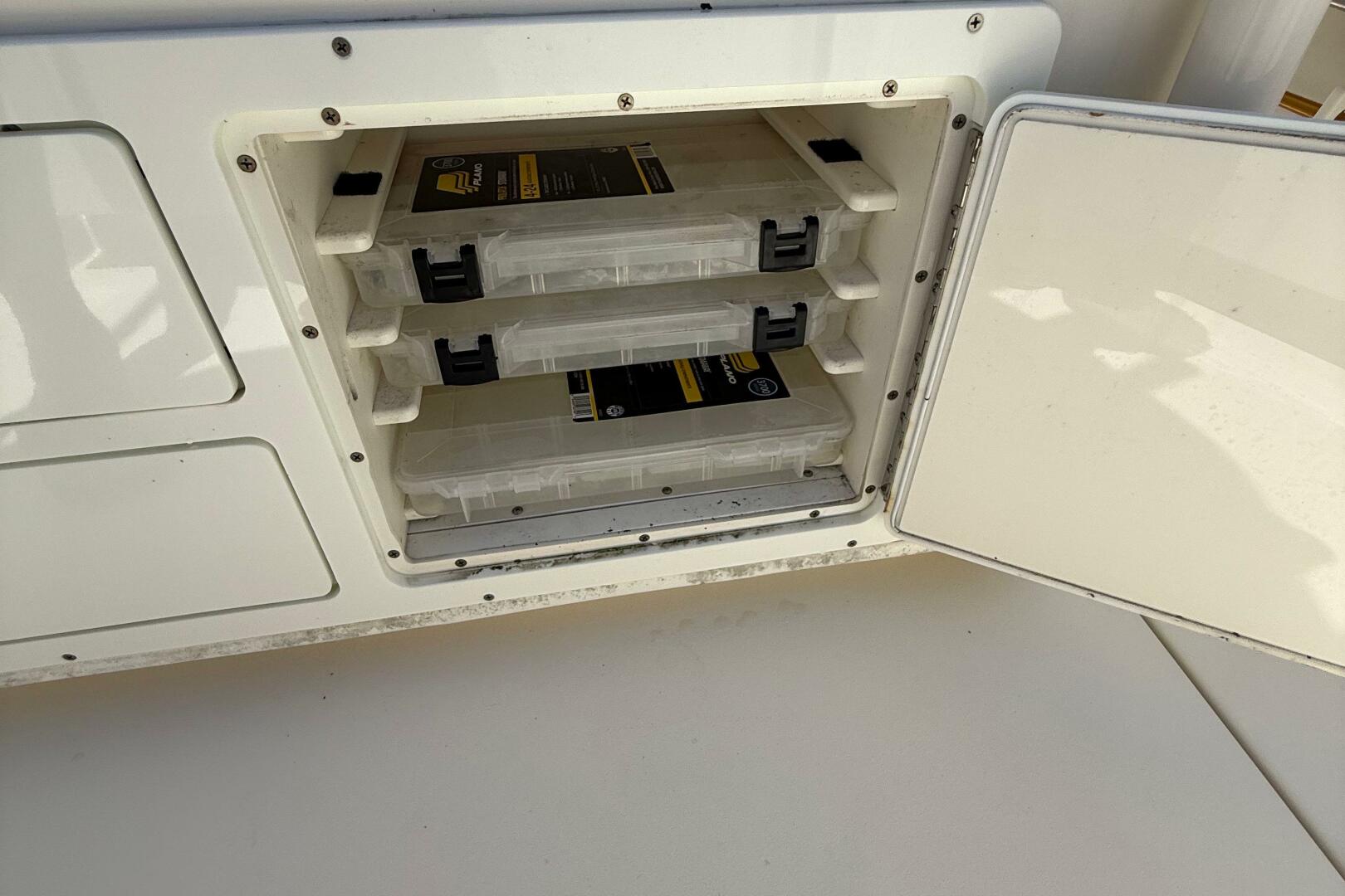 Storage compartment with tackle boxes on a 2015 Cobia 296 Ce