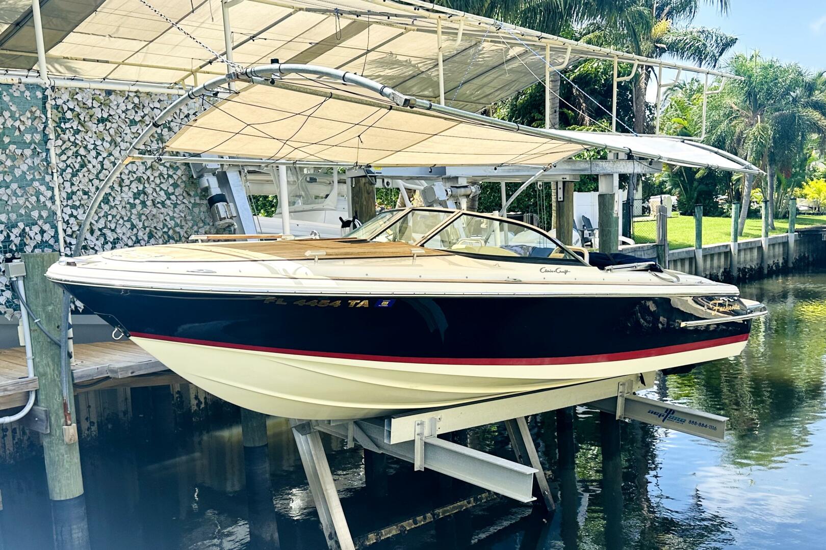 2013 Chris-Craft Corsair 22 boat docked under canopy, surrou