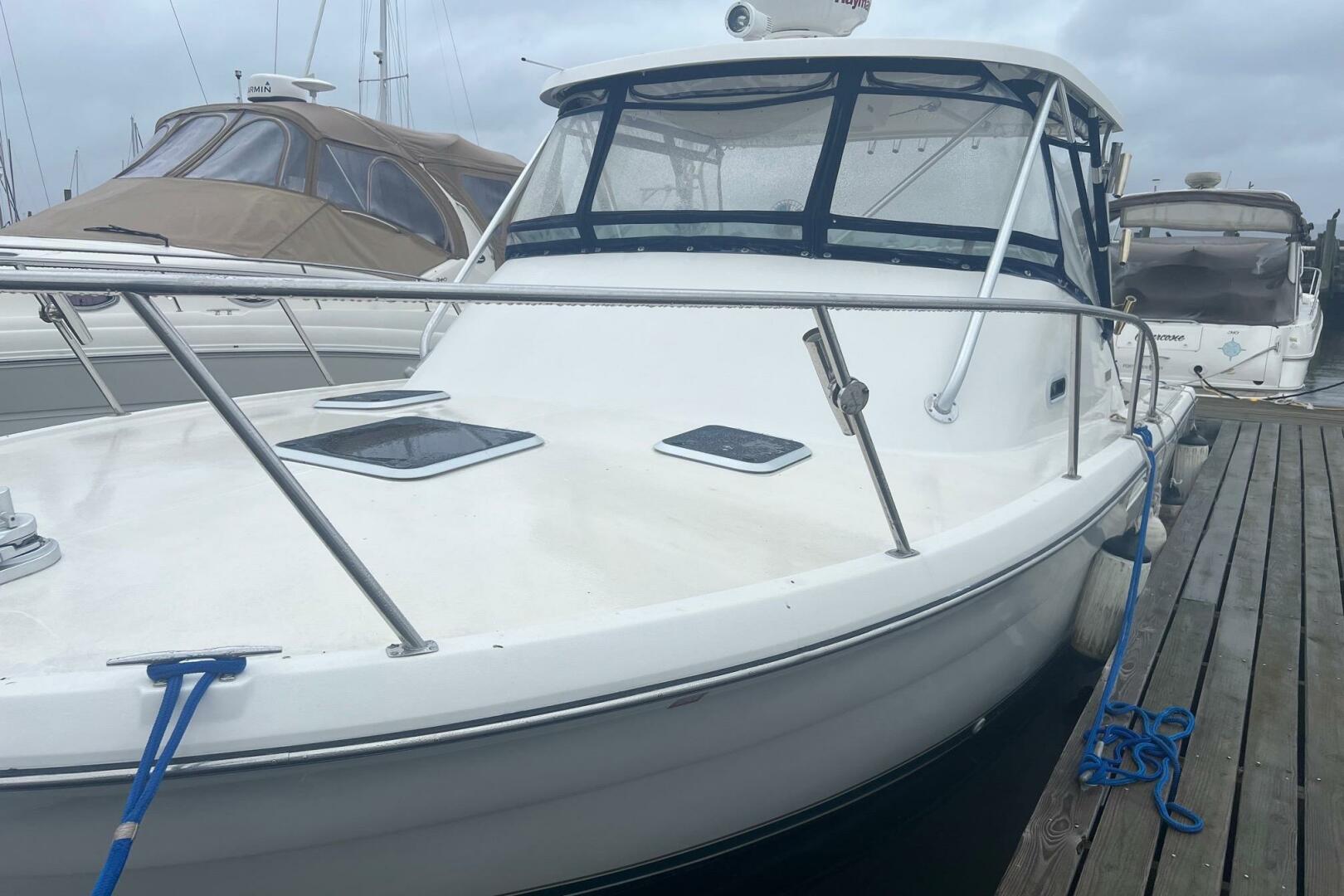 2001 Pursuit 3000 Offshore boat docked at marina, featuring 