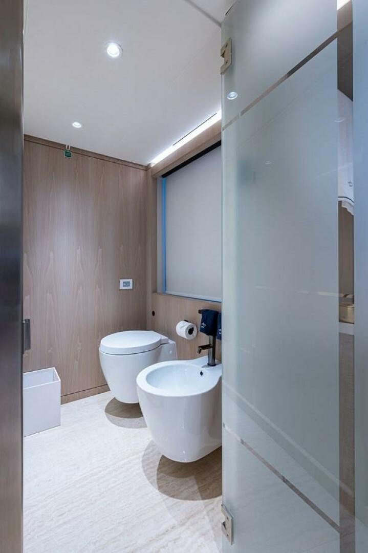 Modern bathroom with toilet and bidet on Majesty 140 yacht, 