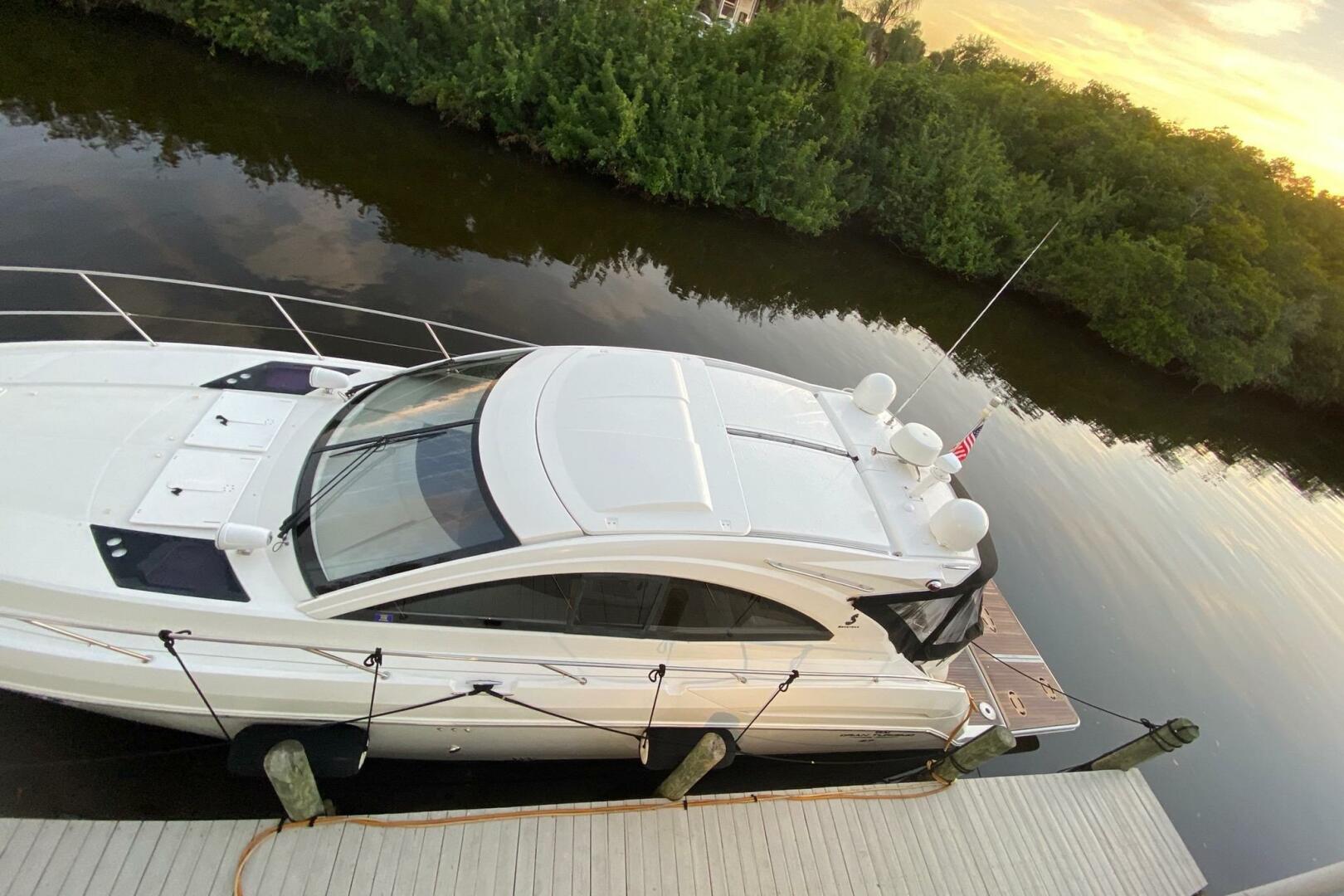 2014 Beneteau Gran Turismo 44 yacht docked by a serene river