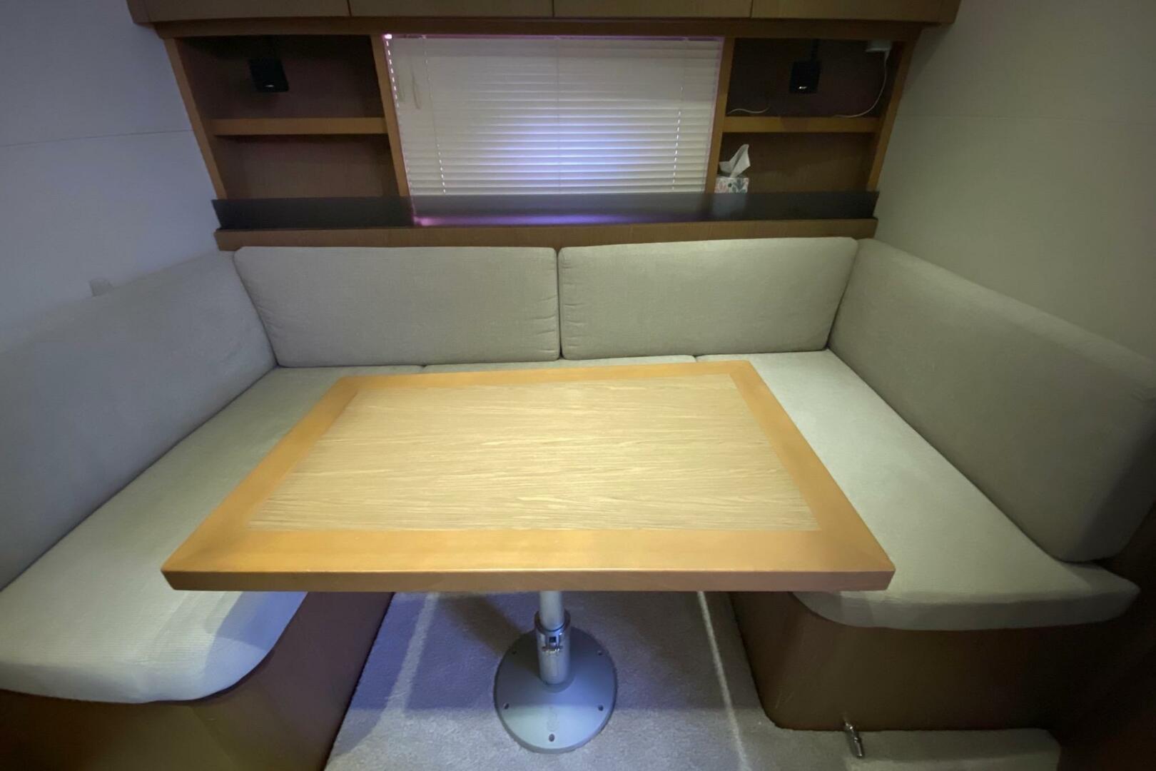 Cozy seating area with table in 2014 Beneteau Gran Turismo 4