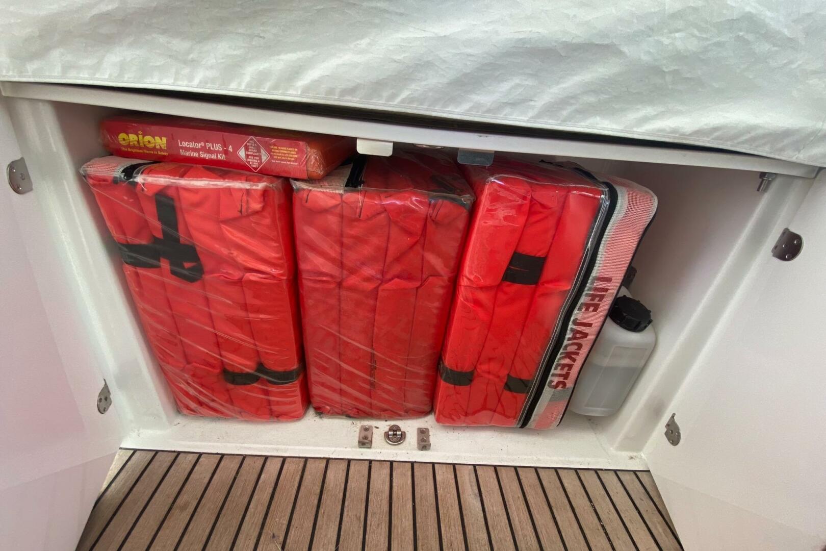 Storage compartment with life jackets and marine signal kit 