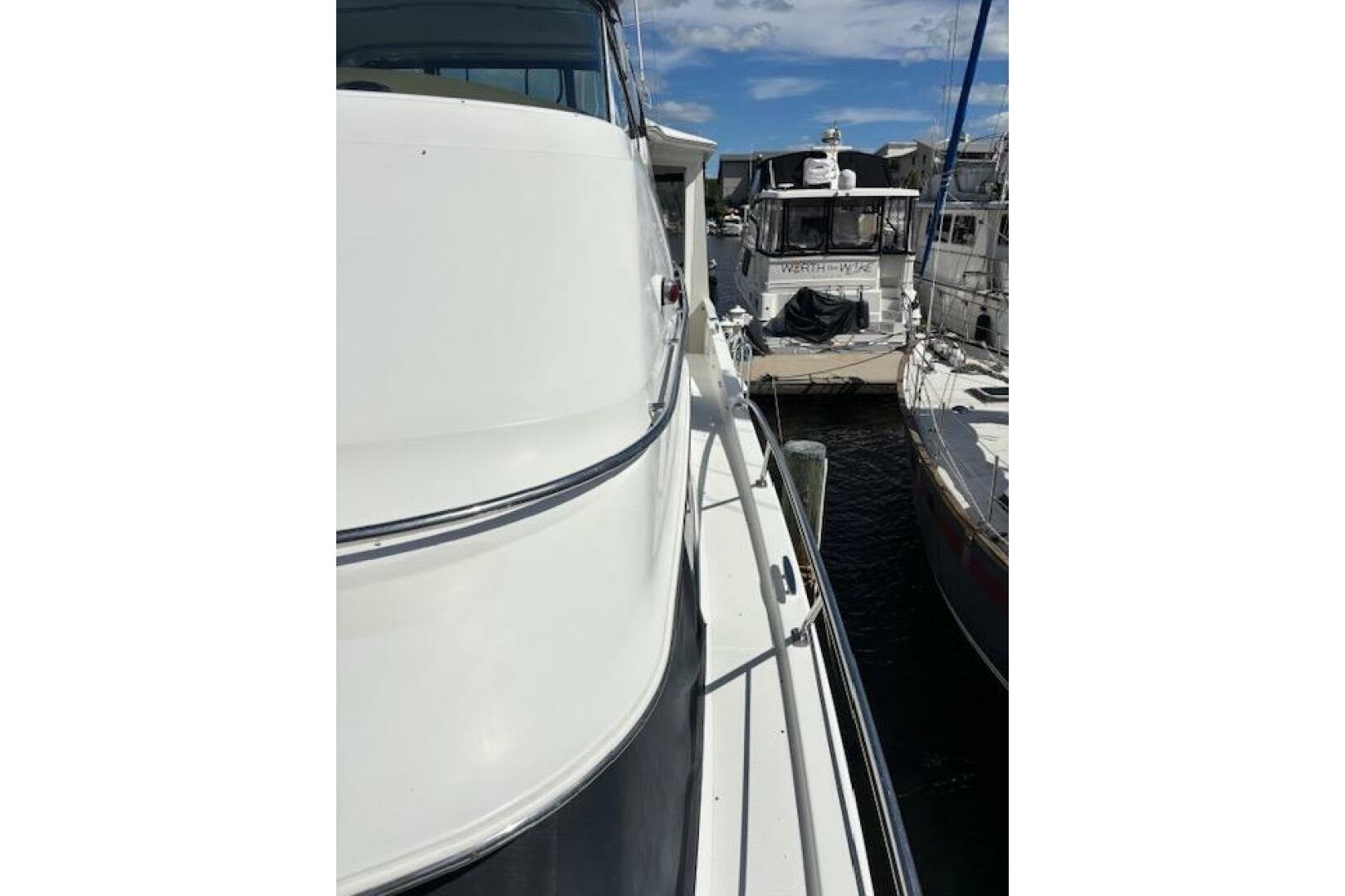 2004 Carver 466 Motor Yacht docked at marina, side view with