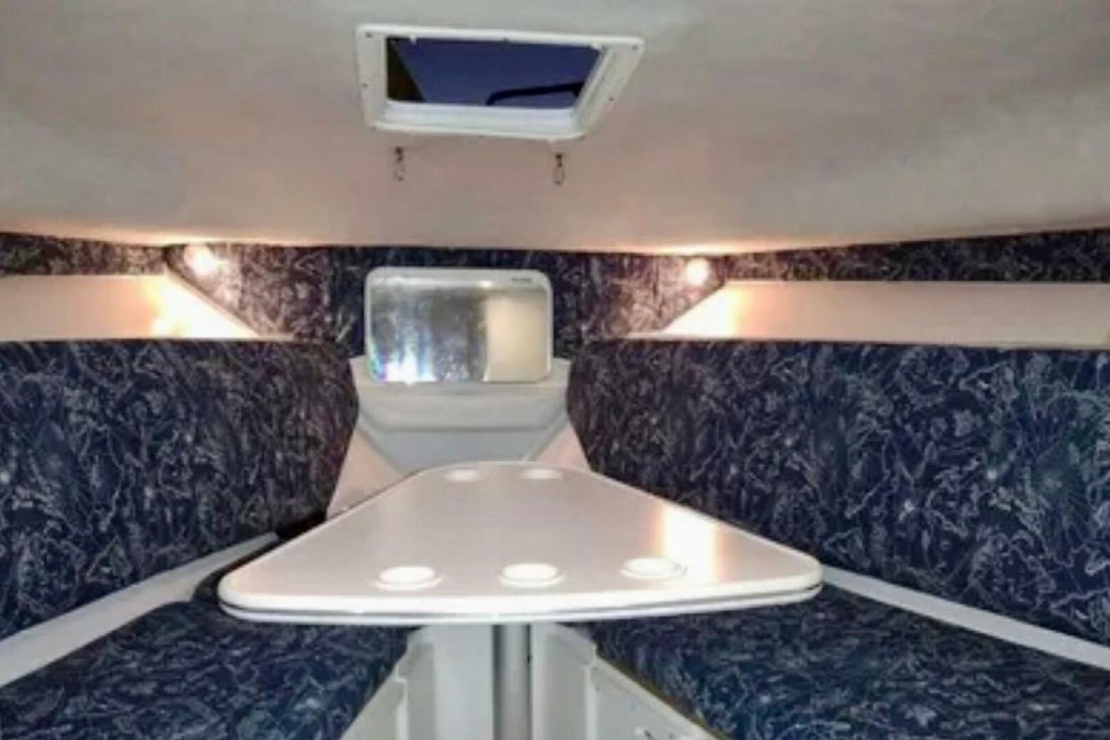 2002 Wellcraft 290 Coastal cabin interior with seating and t
