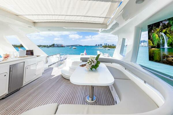 Flybridge dining with TV and Kitchen