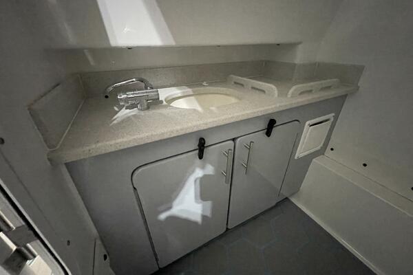Boat Head Sink and Cabinetry Inside Center Console Compartment