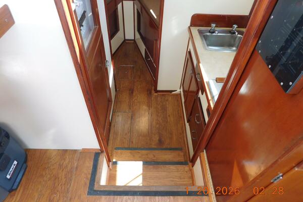 Steps Down To Galley, Head, And Berth. Laminate Wood Flooring.