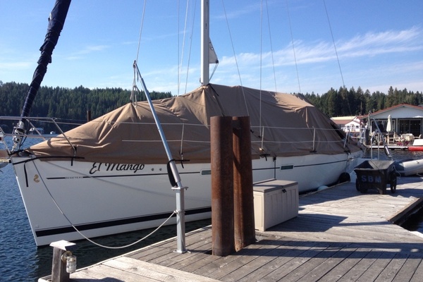 2007 Beneteau 393 sailboat docked with full cover