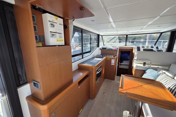 Interior of 2020 Beneteau Swift Trawler 30, featuring large galley and seating with custom table