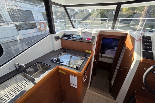 Galley with double sink, two fridges, oven, and dual burner propane cooktop