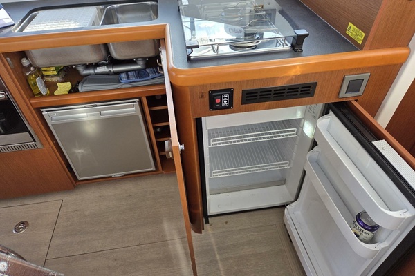 Galley showing main fridge (open) and additional under-sink fridge/freezer