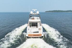 2023 Azimut Fly 53 yacht cruising on open water, rear view.