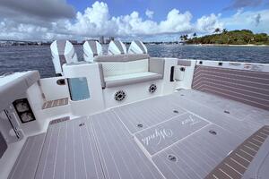 2024 Scout 400 LXF boat deck with seating, ocean view, and four outboard engines.
