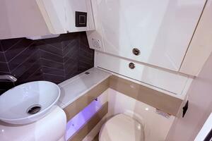 2024 Scout 400 LXF boat bathroom with modern sink and toilet.