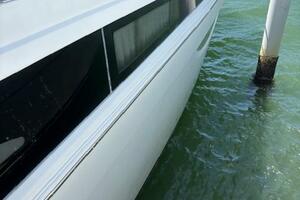 2006 Carver 43 Motor Yacht docked in clear water, side view.