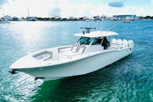 2024 Scout 400 LXF luxury boat cruising on clear blue water.