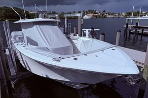 2024 Scout 400 LXF boat docked under cloudy skies.