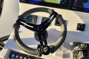 Steering wheel of 2022 CG Boat Works 35 M-Series with navigation controls.