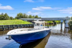2015 Yellowfin 39 boat cruising on a calm river under a blue