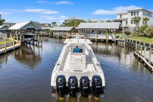 2015 Yellowfin 39 boat docked in a scenic waterfront area wi