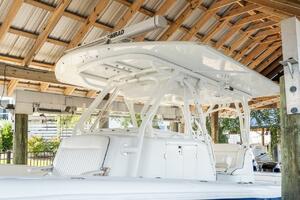 2015 Yellowfin 39 boat under wooden shelter, featuring sleek