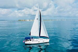 2015 Beneteau Oceanis 45 sailing on calm blue waters under a