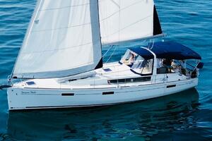2015 Beneteau Oceanis 45 sailing yacht on calm blue waters.