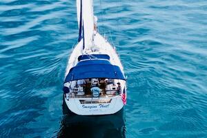 Beneteau Oceanis 45 sailboat on calm blue water, aerial view