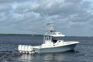 2018 Regulator 41 boat with four engines cruising on open water under cloudy skies.