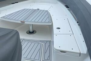 2018 Regulator 41 boat deck with seating and table, docked by the water.