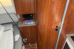 2018 Regulator 41 interior with wood paneling, seating, and fishing rod storage.
