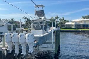 2018 Regulator 41 boat docked with four outboard engines, under a clear blue sky.