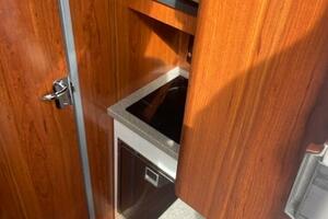 2018 Regulator 41 interior with wood finish, compact kitchen, and modern appliances.