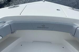 2018 Regulator 41 boat bow with seating, docked by a wooden pier.