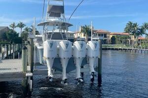 2018 Regulator 41 boat with four engines docked by waterfront homes.